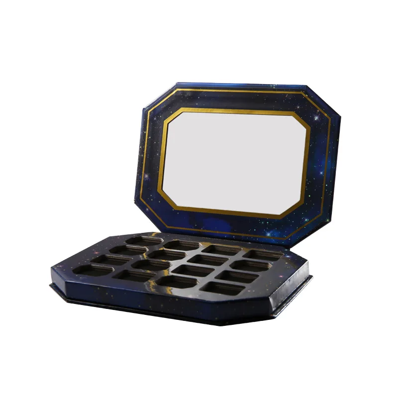 Open dark blue gift box with an empty multi-compartment insert tray